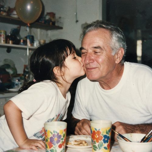 A little girl kissing her grandfather on the cheek